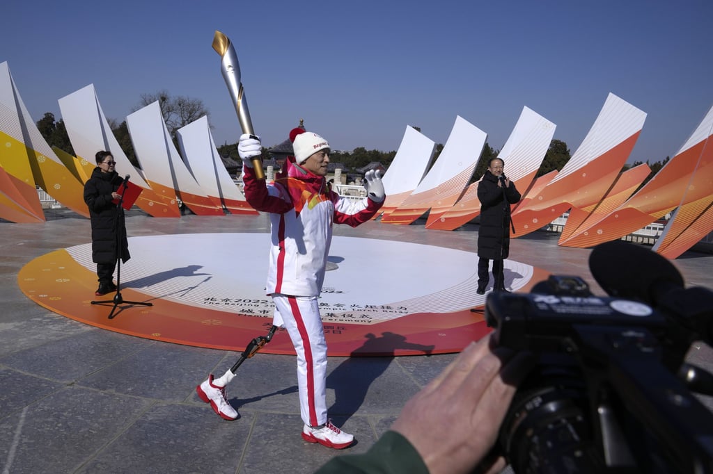 Former Chinese Paralympian Hou Bin holds the Paralympic torch during a flame lighting ceremony for the torch relay of the 2022 Winter Paralympics. Photo: AP