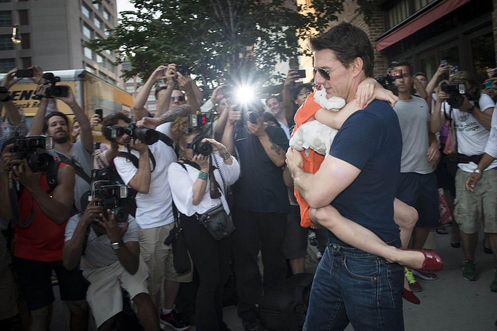 Tom Cruise carries his daughter Suri past a group of photographers in New York, in 2012. Photo: Reuters Tom Cruise carries his daughter Suri past a group of photographers in New York, in 2012. Photo: Reuters