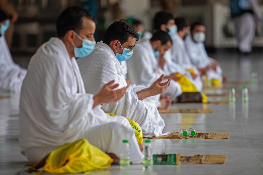 A handout picture obtained from the Saudi ministry of media shows Muslim pilgrims, in protective masks against the spread of the coronavirus, praying in July 2020. Saudi Arabia is lifting most Covid restrictions. Photo: AFP/handout/ Saudi Ministry of Media