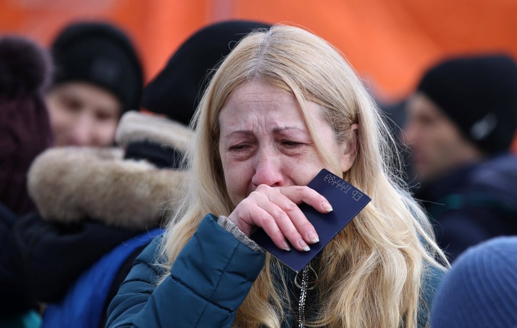 A woman cries as she arrives by ferry after fleeing from Russia’s invasion of Ukraine, at the Isaccea-Orlivka border crossing in Romania on Monday. Photo: Reuters