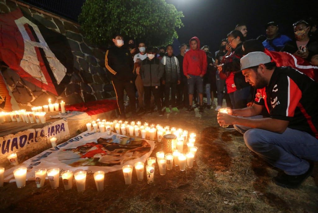 People take part in a vigil after a clash between football fans during a match between Queretaro and Atlas in Queretaro left at least 22 people injured, outside Jalisco Stadium in Guadalajara, Mexico on March 5. Photo: Reuters