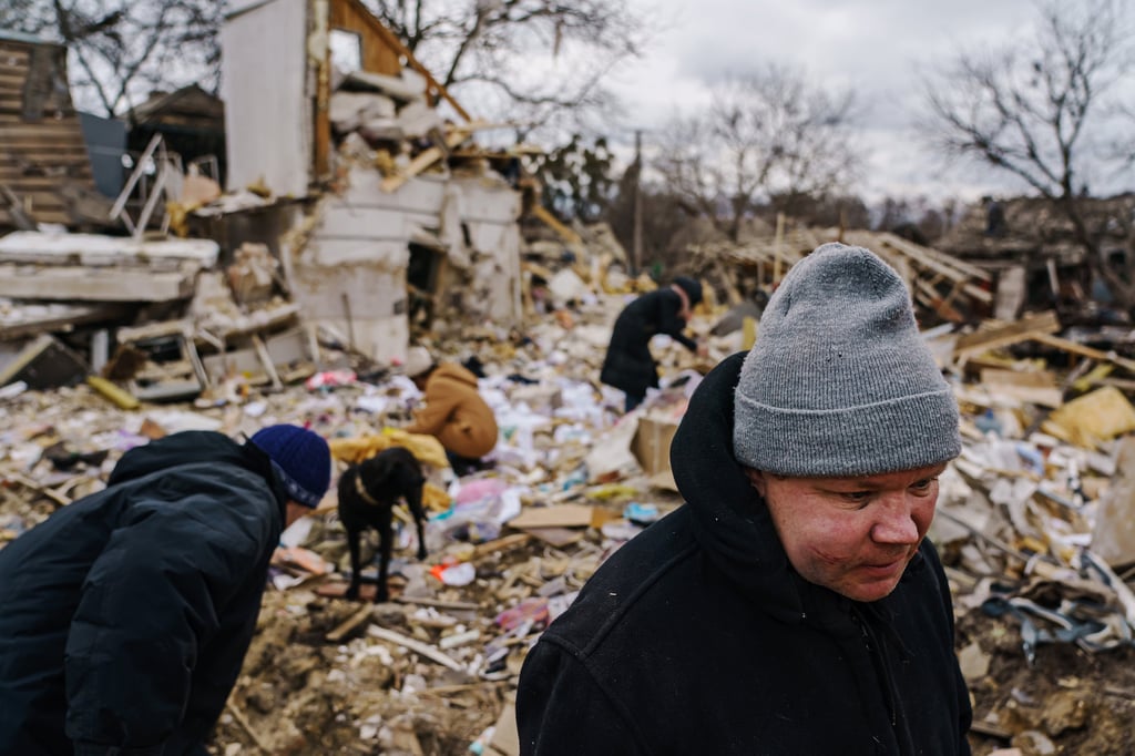 Local residents help Igor Majayev, right, clear the rubble of a home destroyed by a suspected Russian air strike which killed at least six, including Majayev’s relatives, in Markhalivka, Ukraine, on Saturday. Photo: Tribune News Service Local residents help Igor Majayev, right, clear the rubble of a home destroyed by a suspected Russian air strike which killed at least six, including Majayev’s relatives, in Markhalivka, Ukraine, on Saturday. Photo: Tribune News Service