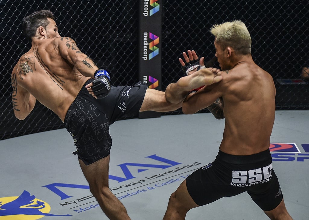 Thanh Le (left) throws a kick at Martin Nguyen in their 2020 title bout. Photo: ONE Championship.