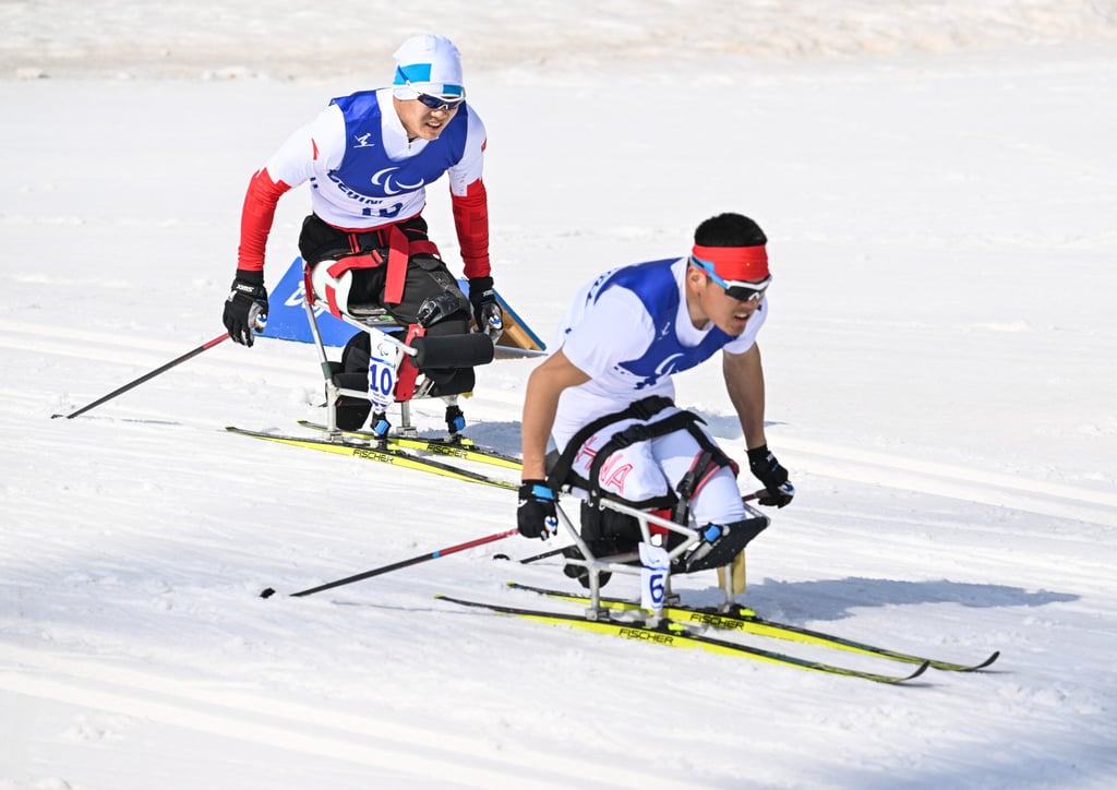 China’s Zhu Yunfeng (left) and Wang Tao compete during the Para Cross-Country Skiing Men’s Sprint Sitting semi-final at the National Biathlon Centre in Zhangjiakou. Photo: Xinhua