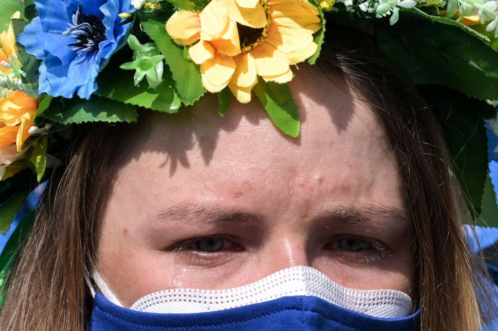 A member of the Ukrainian Winter Paralympics team cries during a moment of silence at the Zhangjiakou Athletes’ Village in Beijing. Photo: AFP