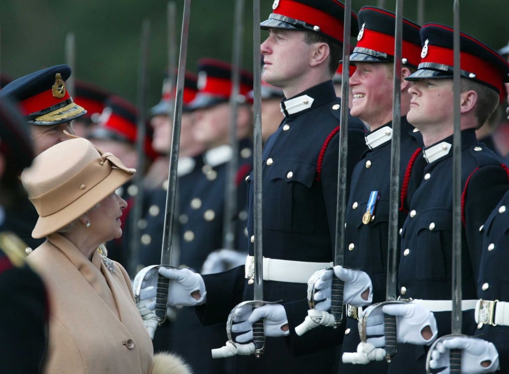 Britain’s Prince Harry, second from right, grins as his grandmother Queen Elizabeth smiles during her inspection of the Sovereign’s Parade at the Royal Military Academy, in 2006. Photo: AP