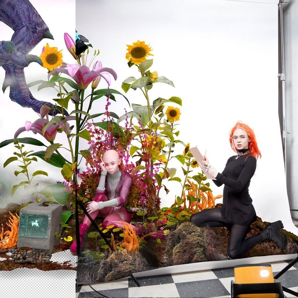 Grimes posing with an artwork an NFT is based off of. Photo: @warnymph/Instagram