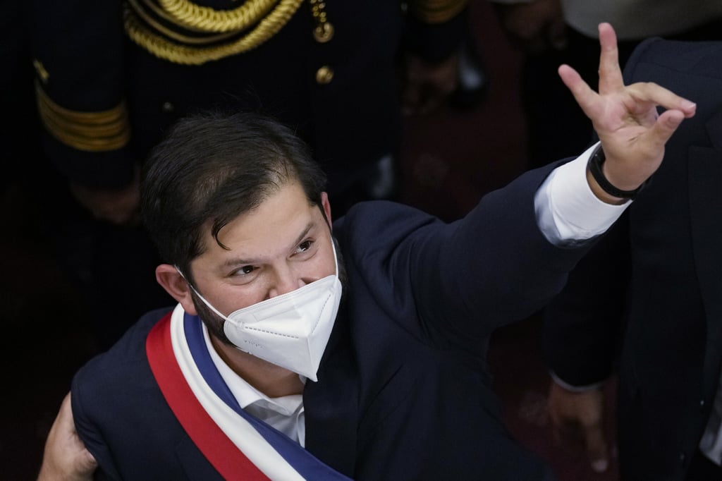 Chile’s new President Gabriel Boric flashes a victory sign after his swearing-in ceremony on Friday in Valparaiso, Chile. Photo: AP