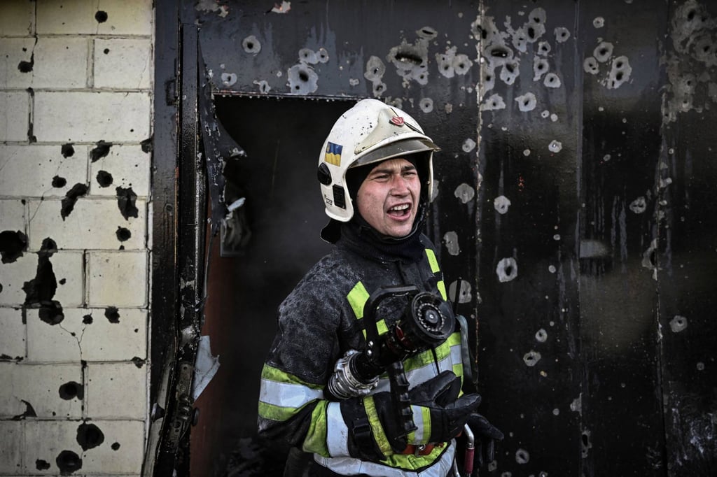 A firefighter in Kyiv where Mayor Vitali Klitschko said defences are being reinforced and food and medicine are being stockpiled. Photo: AFP