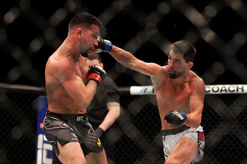 Dominick Cruz punches Pedro Munhoz of Brazil during their bantamweight fight at UFC 269. Photo: AFP Dominick Cruz punches Pedro Munhoz of Brazil during their bantamweight fight at UFC 269. Photo: AFP