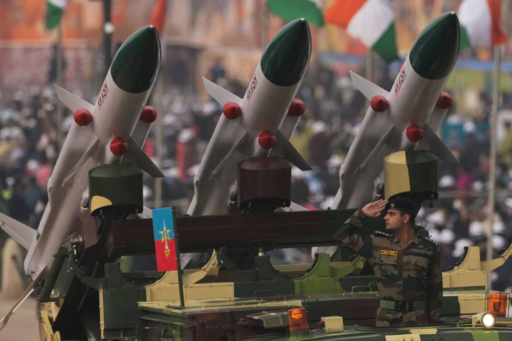A soldier salutes next to an Akash missile system in New Delhi. Photo: AFP