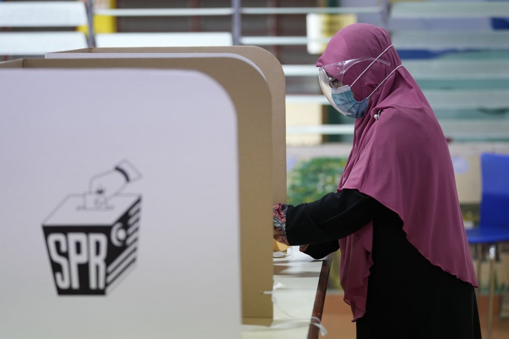 A woman casts her vote during a state election. AP: Photo