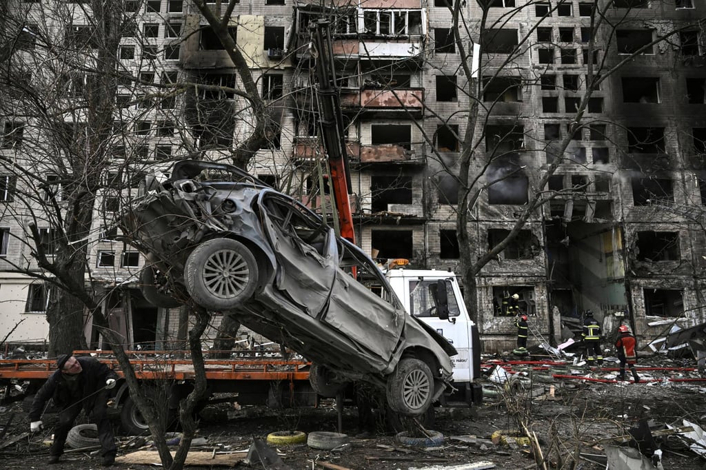 A crane removes a ruined car from the front of a destroyed apartment building in Kyiv on Monday. Two people were killed as various neighbourhoods of the Ukrainian capital were attacked. Photo: AFP A crane removes a ruined car from the front of a destroyed apartment building in Kyiv on Monday. Two people were killed as various neighbourhoods of the Ukrainian capital were attacked. Photo: AFP