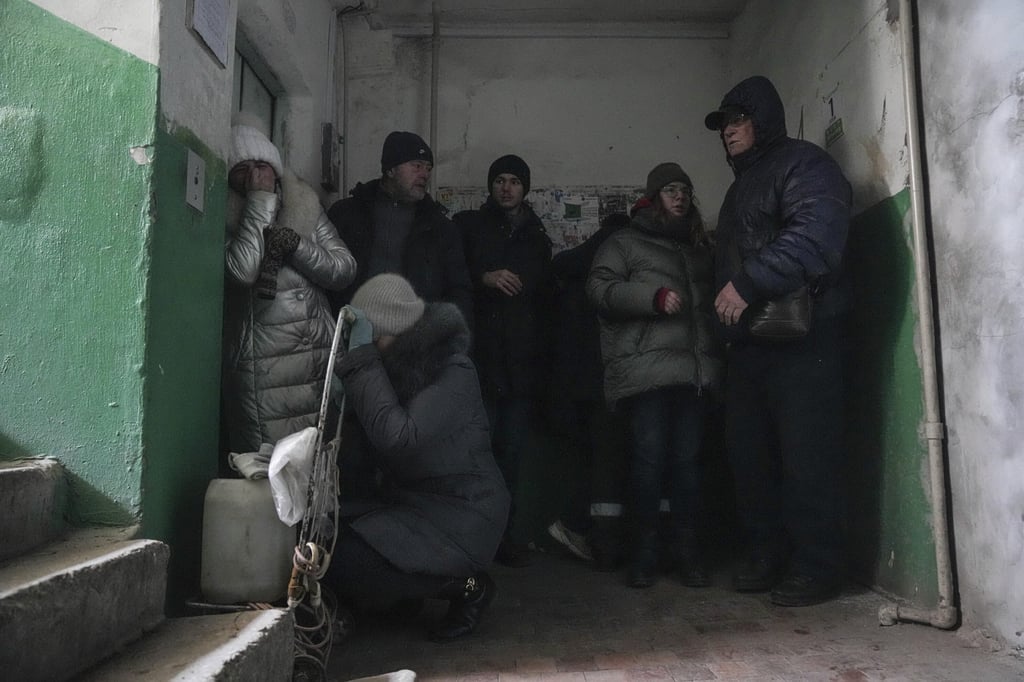 People take cover from shelling in Mariupol, Ukraine, on Sunday. Photo: AP