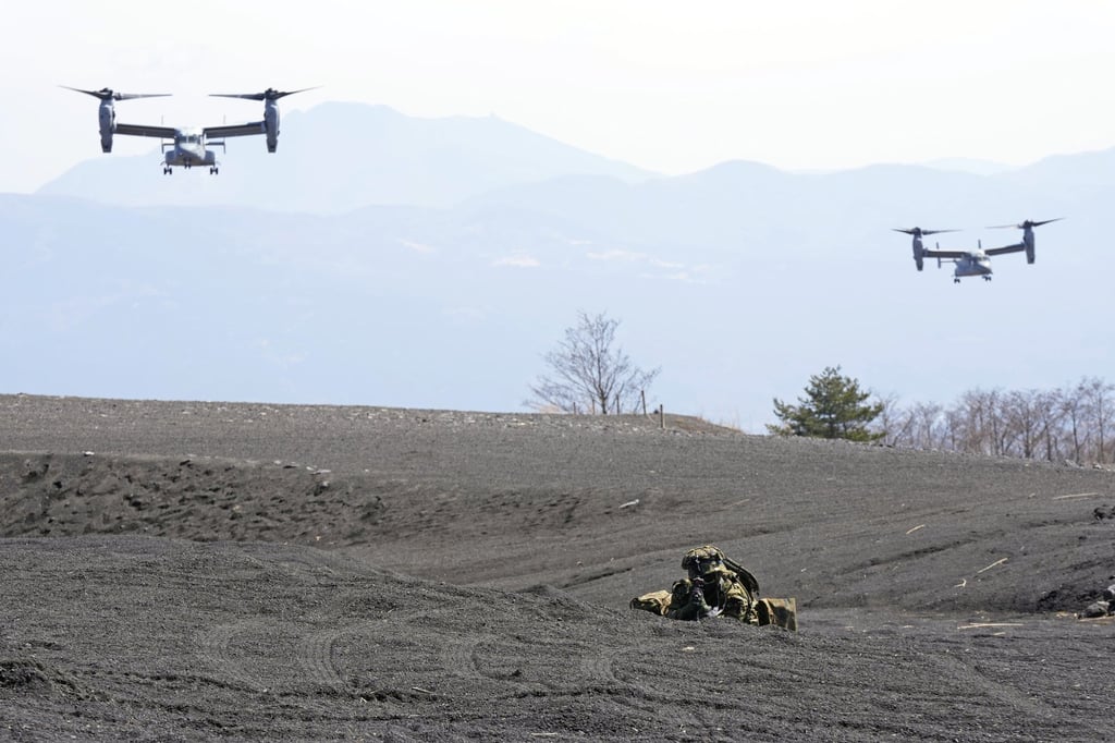 Two MV-22 Ospreys fly above during a joint military drill between Japanese and US marines southwest of Tokyo on Tuesday. Photo: AP