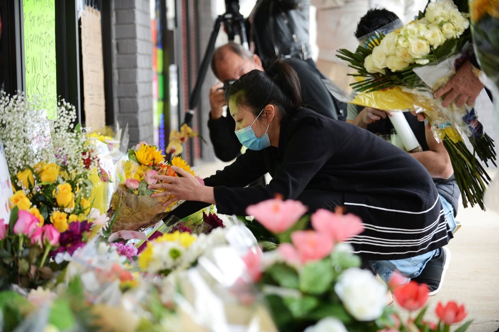 Shooting victim Xiaojie Tan’s daughter Jami Webb places flowers outside Young’s Asian Massage in Acworth, Georgia, in March 2021. Photo: Reuters