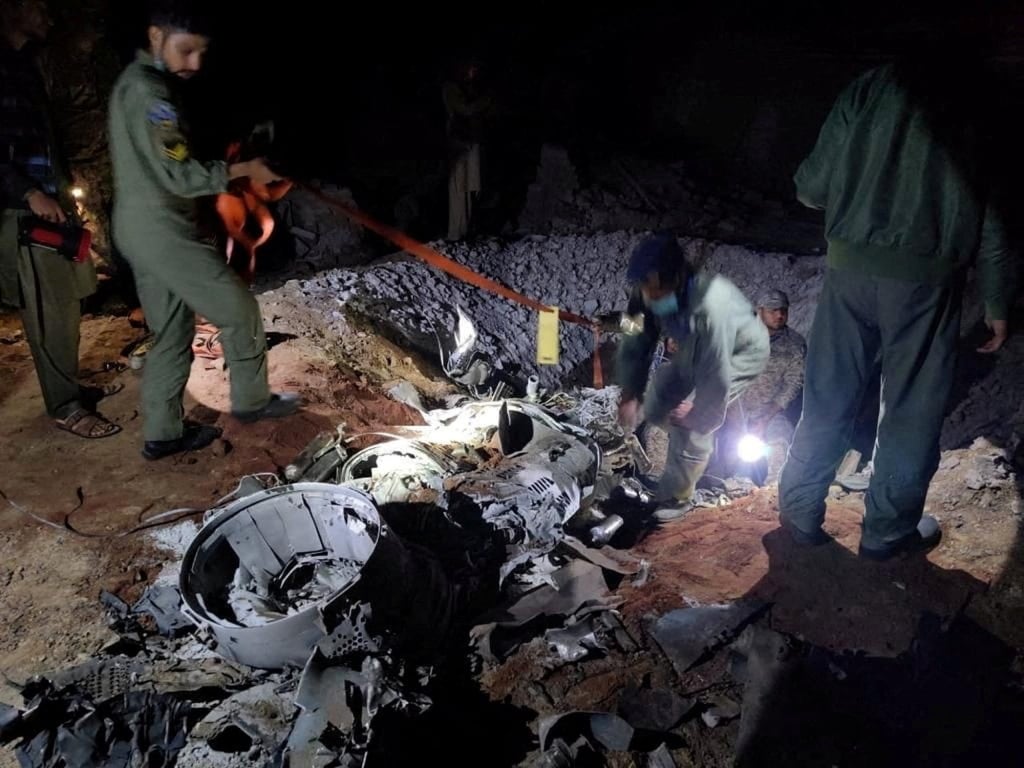 Security forces inspect the remains of a missile fired from India, near Mian Channu, Pakistan. Photo: Reuters