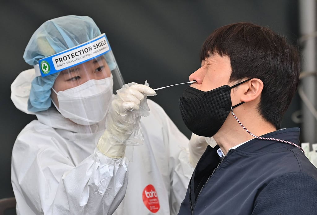 A medical worker takes a nasal swab from a man at a Covid-19 testing centre in Seoul. Photo: AFP A medical worker takes a nasal swab from a man at a Covid-19 testing centre in Seoul. Photo: AFP