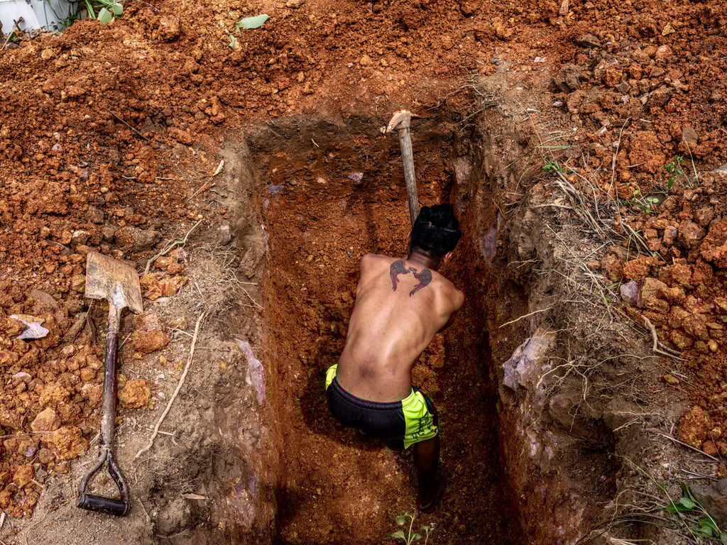 Markjay Belacruz digs a grave in Bambang for his cousin, a suspected victim of Covid-19, in May 2020. Photo: Xyza Cruz Bacani / Christine Park Gallery Markjay Belacruz digs a grave in Bambang for his cousin, a suspected victim of Covid-19, in May 2020. Photo: Xyza Cruz Bacani / Christine Park Gallery