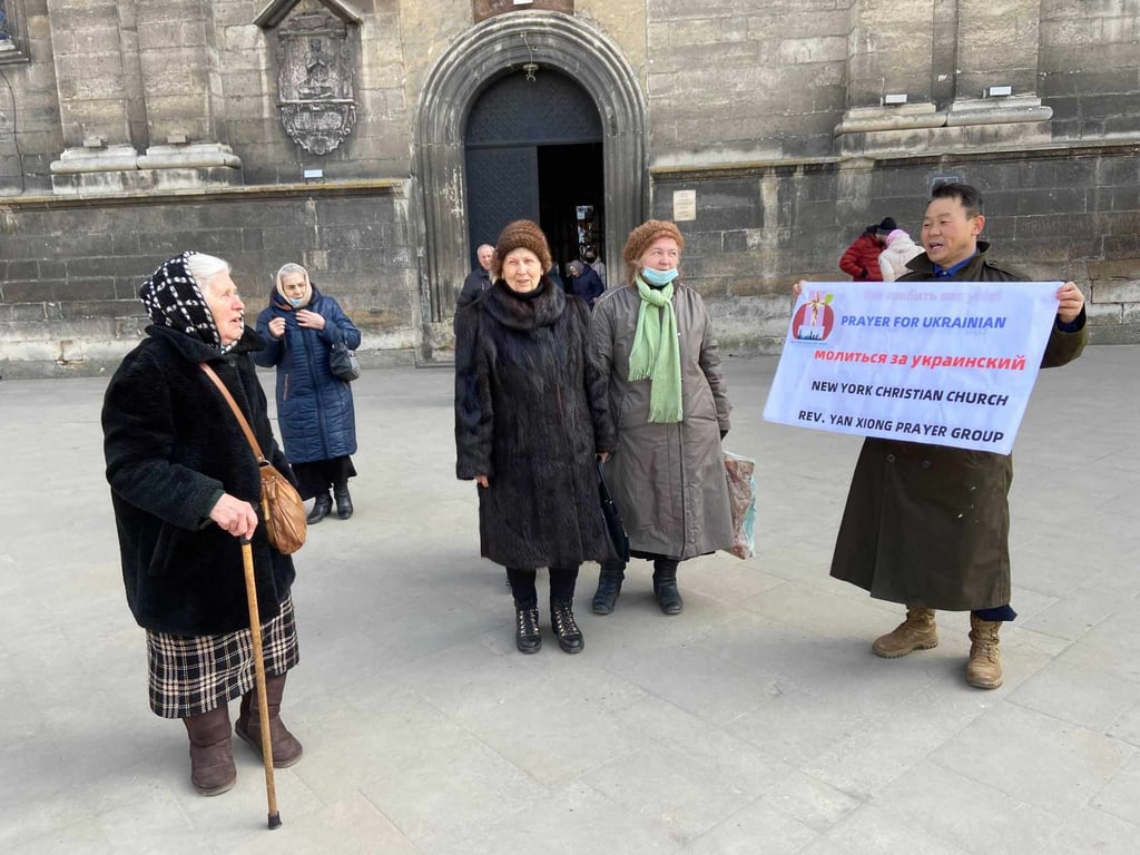 Xiong Yan, a US congressional candidate, holds a sign in support of Ukraine while on a trip to the country’s western city of Lviv this month.