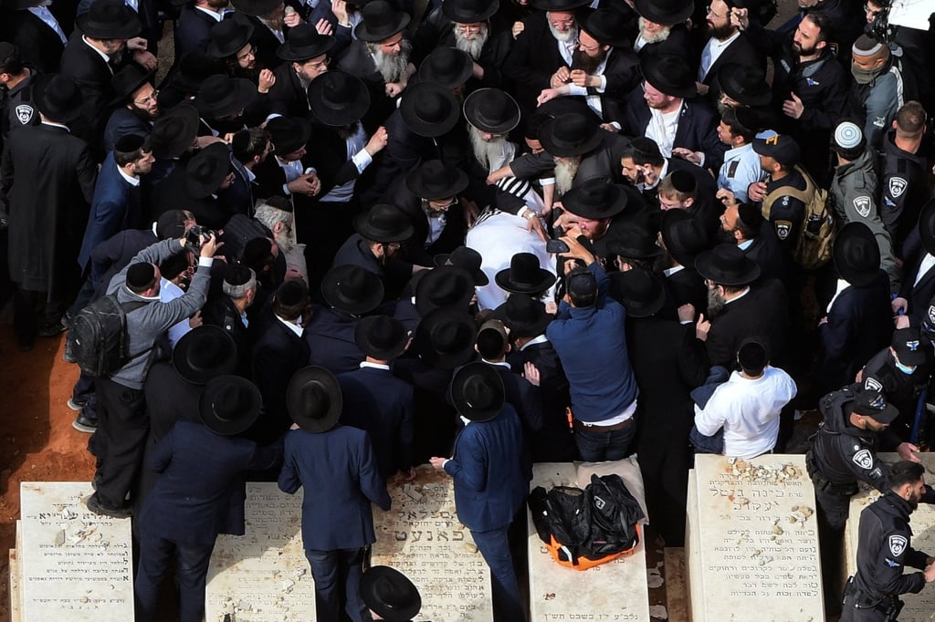 Ultra-Orthodox Jewish men carry the body of prominent rabbi Chaim Kanievsky who died at 94, near his burial plot in Bnei Brak, near Tel Aviv, Israel on March. Photo: Reuters