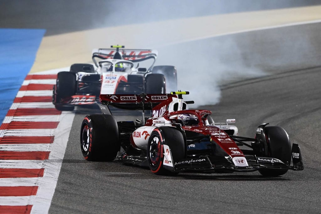 Alfa Romeo’s Zhou Guanyu (front), and Haas’ German driver Mick Schumacher battle for position during the Bahrain Grand Prix on Sunday. Photo: AFP