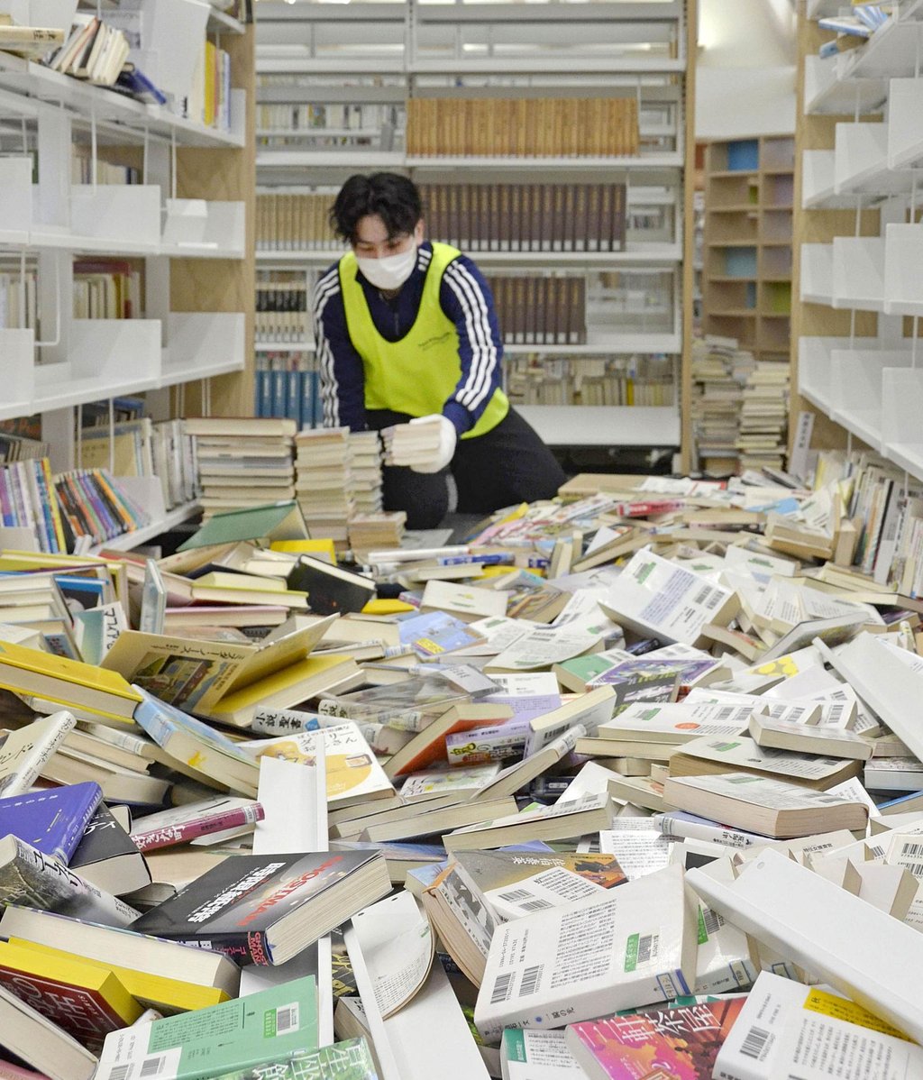 A student volunteer helps to return books to shelves in a library in the Fukushima Prefecture town of Yabuki on Tuesday following a powerful earthquake last week. Photo: Kyodo A student volunteer helps to return books to shelves in a library in the Fukushima Prefecture town of Yabuki on Tuesday following a powerful earthquake last week. Photo: Kyodo