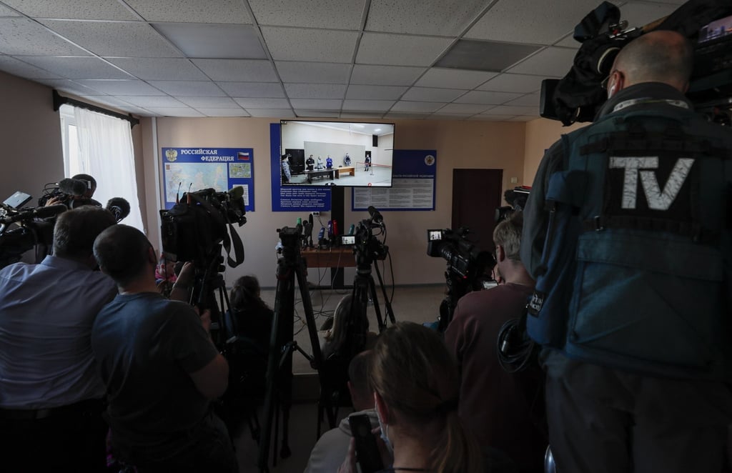 Journalists watch a screen showing the off-site court session of Russian opposition leader and activist Alexei Navalny on Tuesday. Photo: EPA-EFE Journalists watch a screen showing the off-site court session of Russian opposition leader and activist Alexei Navalny on Tuesday. Photo: EPA-EFE