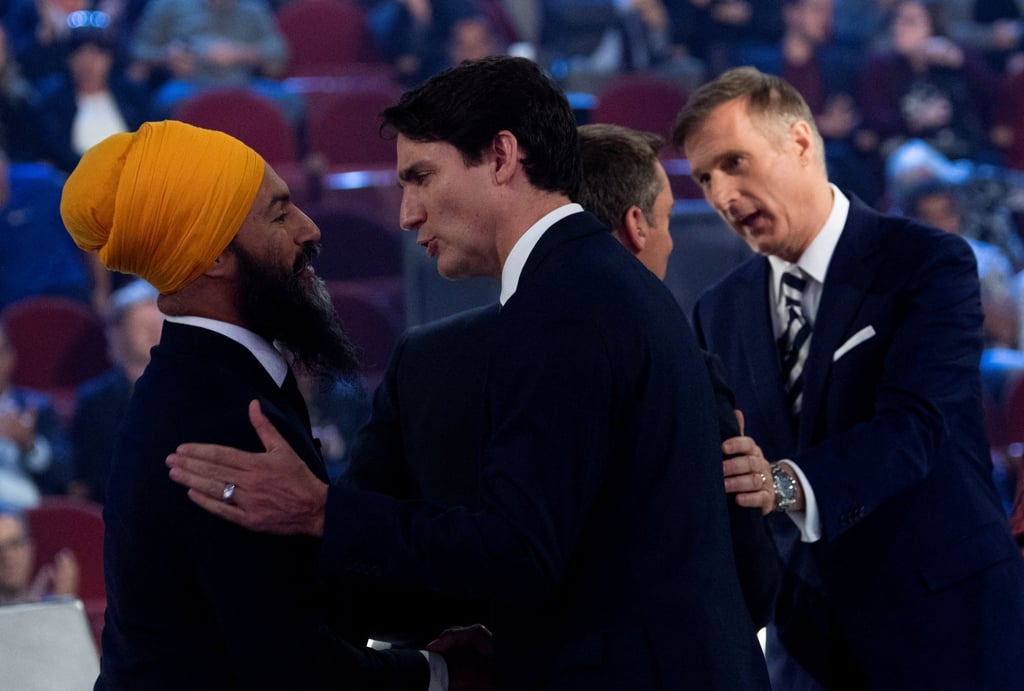 Canadian PM Justin Trudeau (centre) and NDP leader Jagmeet Singh shake hands following the Federal leaders French language debate in Gatineau, Quebec in October 2019. Photo: Reuters Canadian PM Justin Trudeau (centre) and NDP leader Jagmeet Singh shake hands following the Federal leaders French language debate in Gatineau, Quebec in October 2019. Photo: Reuters