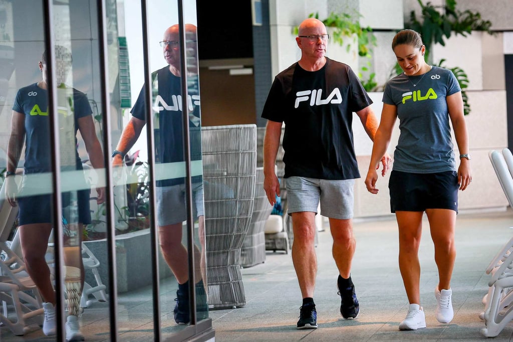 Ashleigh Barty with coach Craig Tyzzer walk to Thursday’s press conference in Brisbane. Photo: AFP