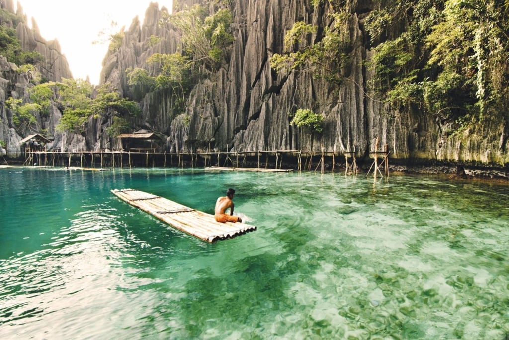 Stunning limestone cliffs flank the crystal-clear coastal waters of the island of Coron. Photo: Department of Tourism – Philippines