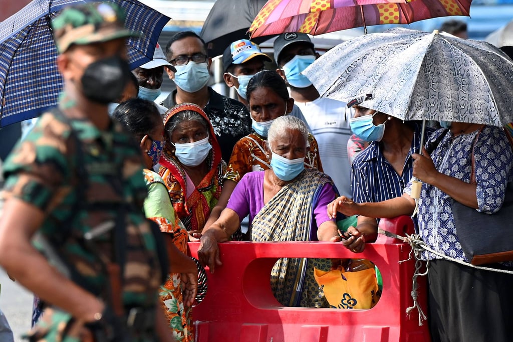 A soldier guards a petrol station as people wait to get fuel in Colombo on Wednesday. Photo: AFP A soldier guards a petrol station as people wait to get fuel in Colombo on Wednesday. Photo: AFP