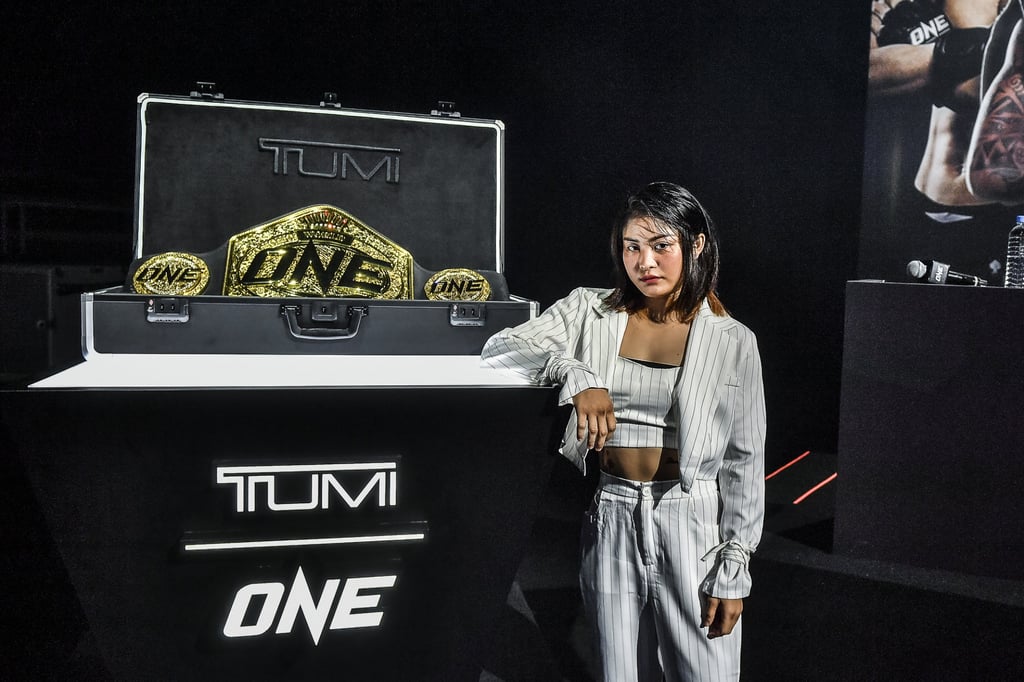 Stamp Fairtex stands next to the new ONE Championship world title – which she hopes to win at ONE X in Singapore. Stamp Fairtex stands next to the new ONE Championship world title – which she hopes to win at ONE X in Singapore.