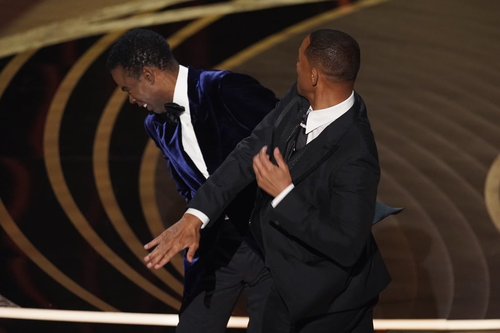 Will Smith hits presenter Chris Rock on stage while presenting the award for best documentary feature at the Oscars on Sunday. Photo: AP Will Smith hits presenter Chris Rock on stage while presenting the award for best documentary feature at the Oscars on Sunday. Photo: AP