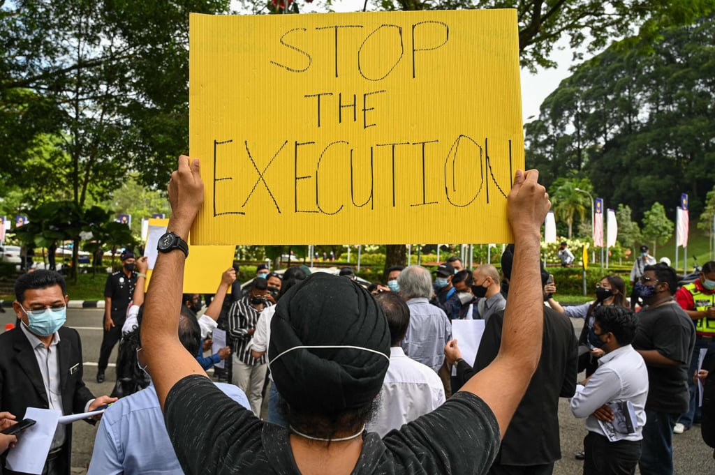 An activist in Kuala Lumpur holds a placard protesting against Nagaenthran’s execution before submitting a memorandum to Malaysia’s parliament in November last year. Photo: AFP An activist in Kuala Lumpur holds a placard protesting against Nagaenthran’s execution before submitting a memorandum to Malaysia’s parliament in November last year. Photo: AFP