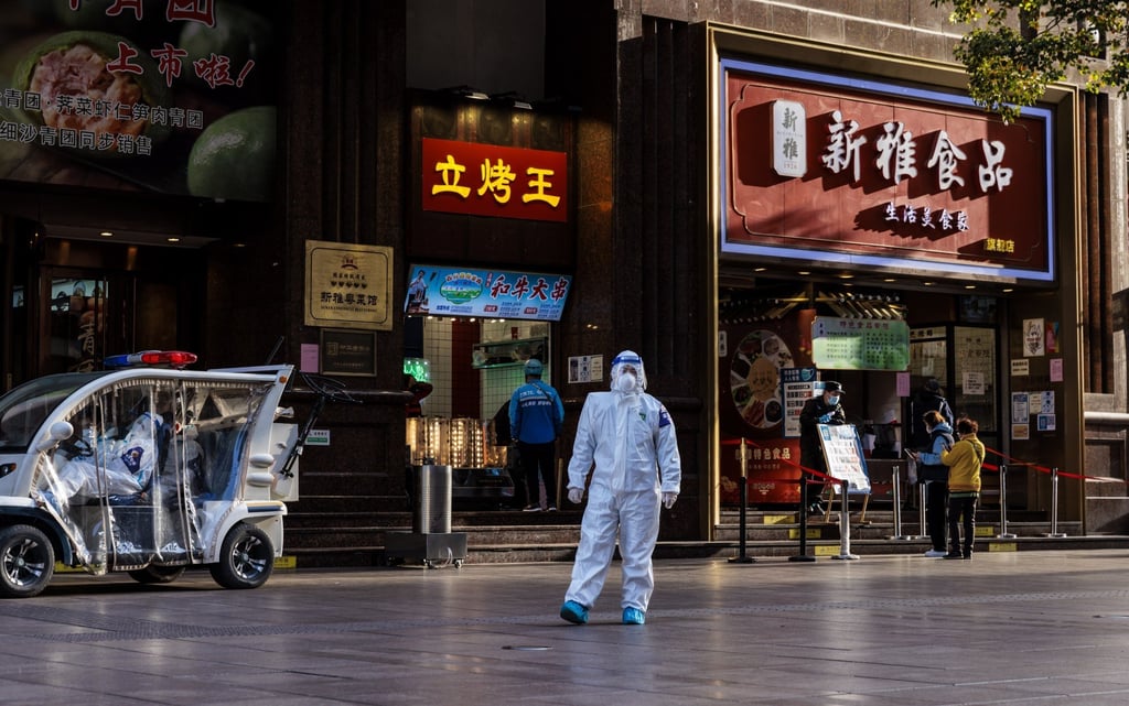 Police in protective gear on the Nanjing Street thoroughfare in Shanghai on March 28, 2022, usually teeming with pedestrians and tourists on most days. Photo: EPA-EFEI
