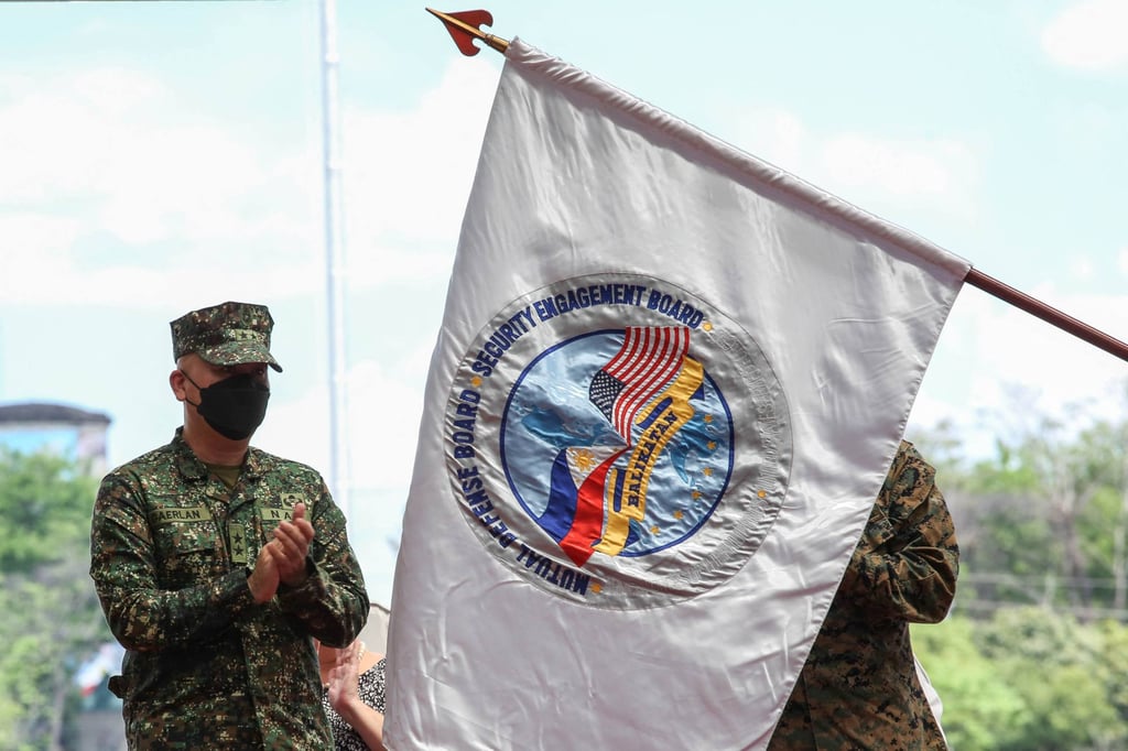 Philippine Balikatan exercise director Major General Charlton Sean Gaerlan claps as the Balikatan flag is unfurled. Photo: AFP