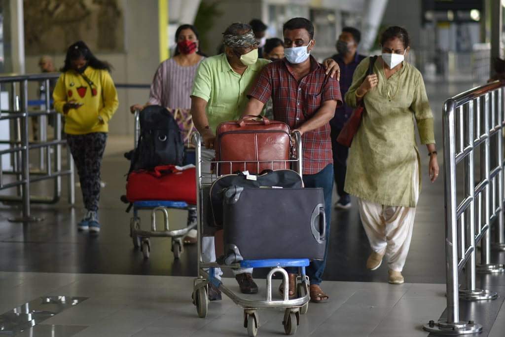 International passengers arrive at Chennai airport on March 27, the day India’s regular overseas flight services resumed. Photo: EPA
