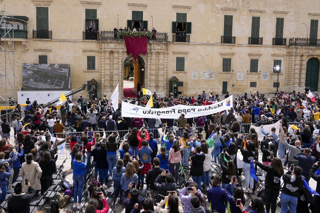 People gathered in Valletta, Malta, on Saturday, to cheer Pope Francis, seen on a balcony. Photo: AP