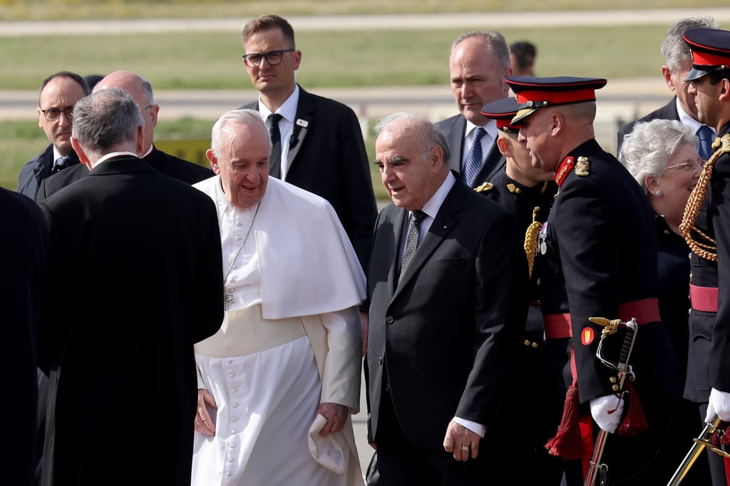 Pope Francis is greeted by the President of Malta, George Abela (C), on his arrival in Malta. Photo: EPA-EFE