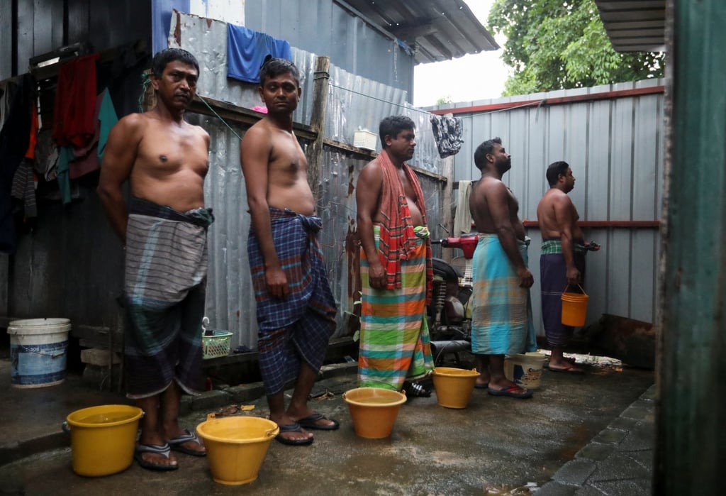 Migrant workers wait for their turn to use one of the four toilets shared among 104 construction workers at their dormitory in Kuala Lumpur, Malaysia in March, 2022. Photo: Reuters