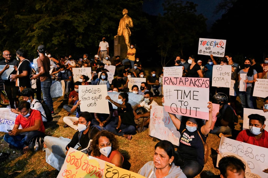 Protesters hold banners and placards during a demonstration against the surge in prices and shortage of fuel and other essential commodities in Colombo on Friday. Photo: AFP
