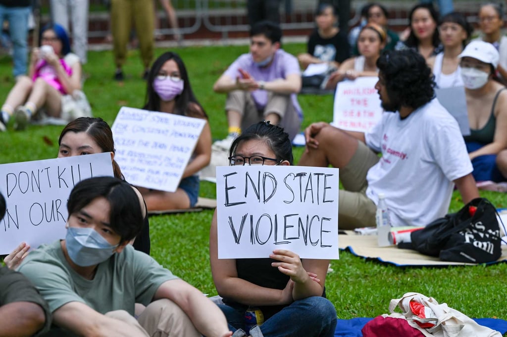 People hold signs during a protest against the death penalty in Singapore on Sunday. Photo: AFP People hold signs during a protest against the death penalty in Singapore on Sunday. Photo: AFP