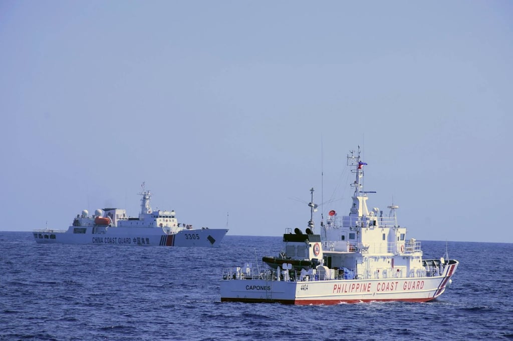 A Chinese ship, left, approaches a Philippine coastguard vessel conducting a patrol near Scarborough Shoal in the South China Sea on March 2. Photo: Philippine Coast Guard Handout via AFP