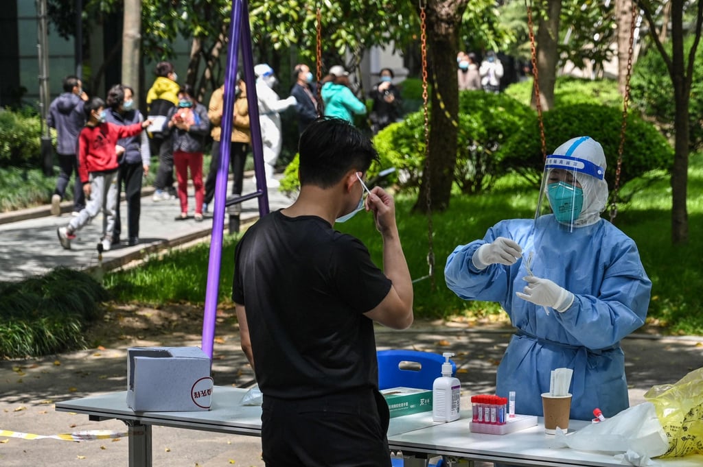 A health worker prepares to conduct a swab test for the Covid-19 coronavirus at a residential compound during the second stage of a pandemic lockdown in Jing’ an district in Shanghai on April 6, 2022. Photo: Agence France-Presse