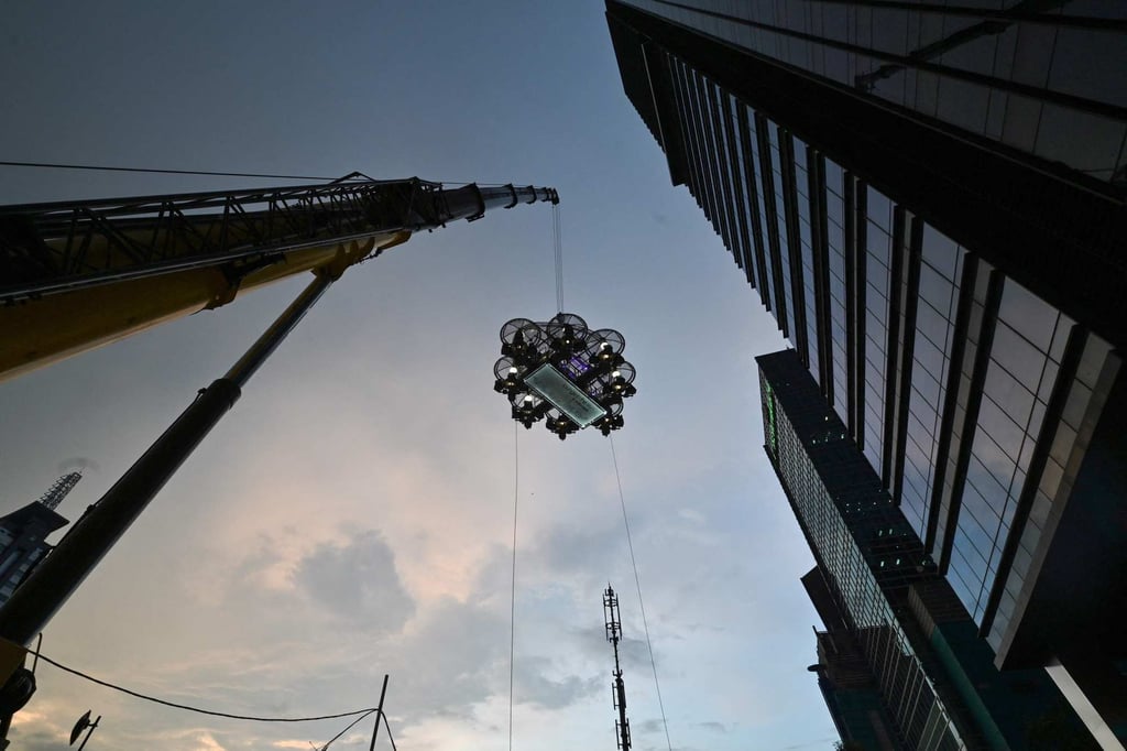 Guests enjoy dinner some 50 meters above ground at the Lounge in the Sky, in Jakarta. Photo: AFP