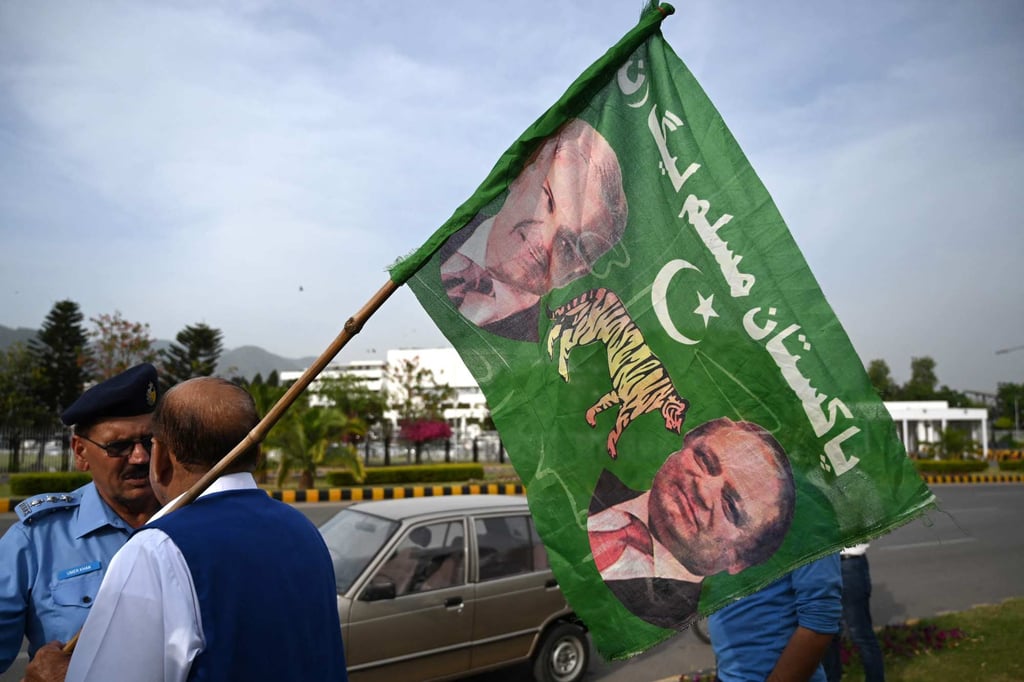 A Pakistan Muslim League-Nawaz supporter holds a party flag bearing images of Shehbaz Sharif (left) and Nawaz Sharif, outside the parliament building in Islamabad on Monday. Photo: AFP A Pakistan Muslim League-Nawaz supporter holds a party flag bearing images of Shehbaz Sharif (left) and Nawaz Sharif, outside the parliament building in Islamabad on Monday. Photo: AFP