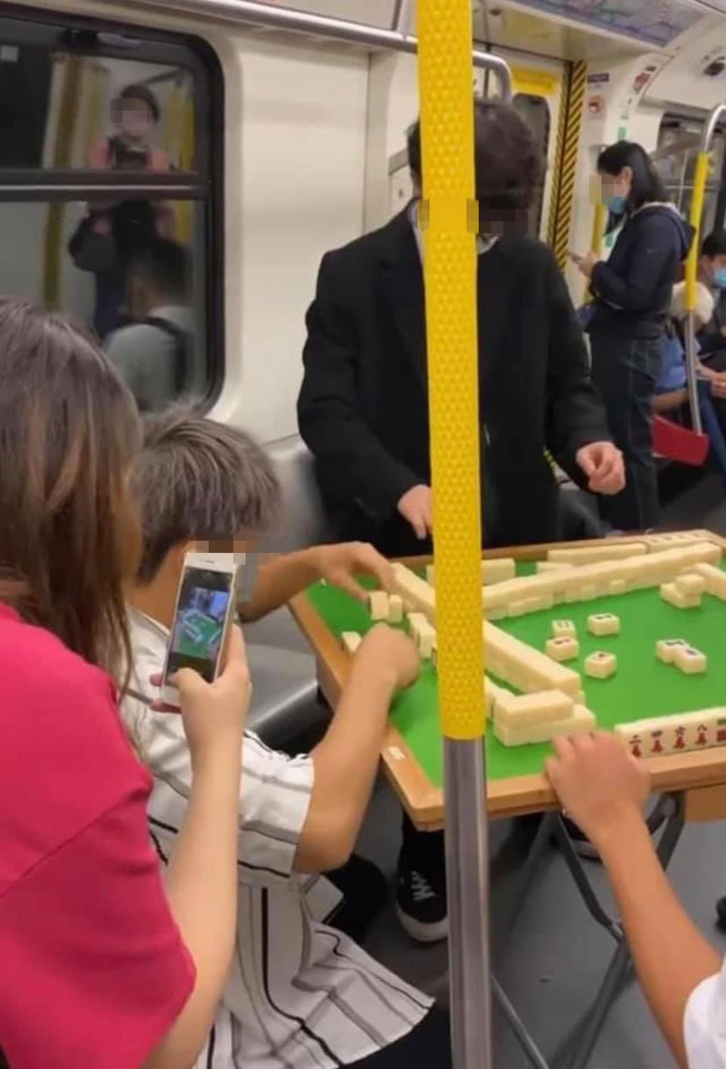 A social media video shows the five men playing mahjong in an MTR train in October, 2021. Photo: Handout A social media video shows the five men playing mahjong in an MTR train in October, 2021. Photo: Handout
