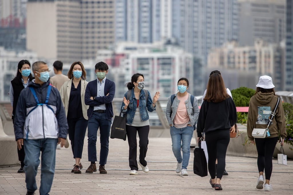People pictured wearing face masks in Hong Kong last month. Lee said the departure of expats from the city ‘tired of Covid-19 restrictions’ was only short term. Photo: EPA People pictured wearing face masks in Hong Kong last month. Lee said the departure of expats from the city ‘tired of Covid-19 restrictions’ was only short term. Photo: EPA