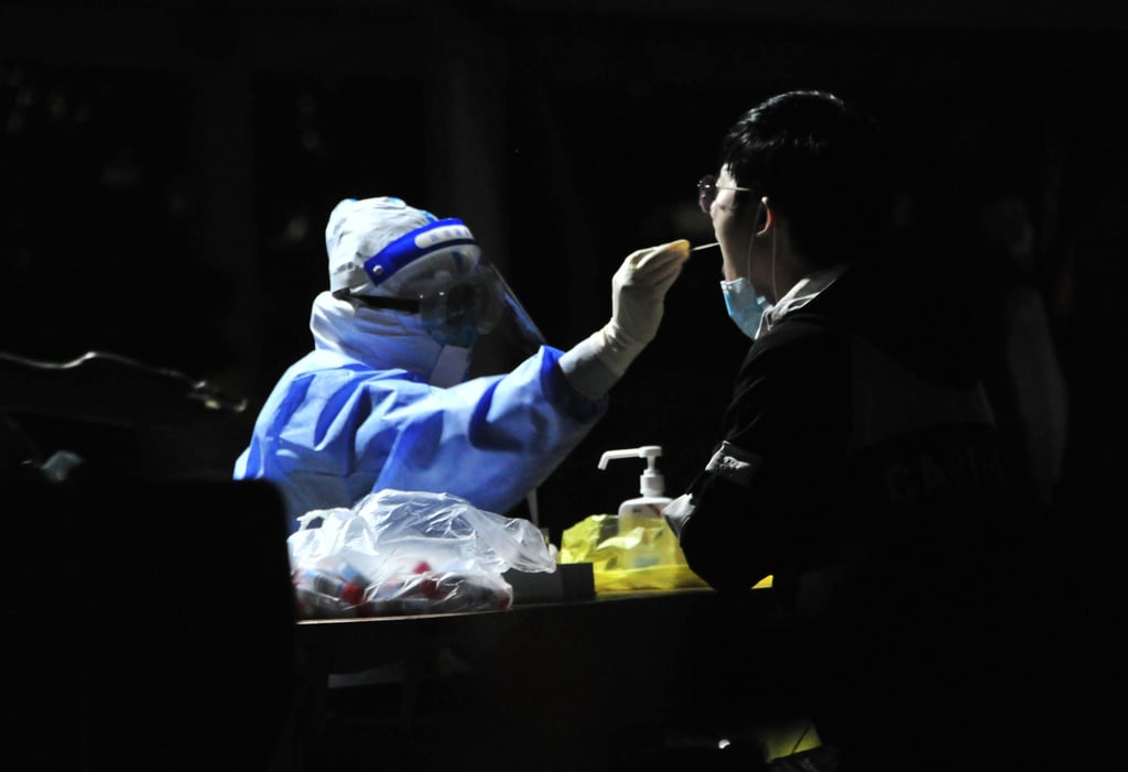A medical worker takes a swab sample from a resident for Covid-19 nucleic acid test at a residential community on April 9 in Shanghai, China. Photo: Getty